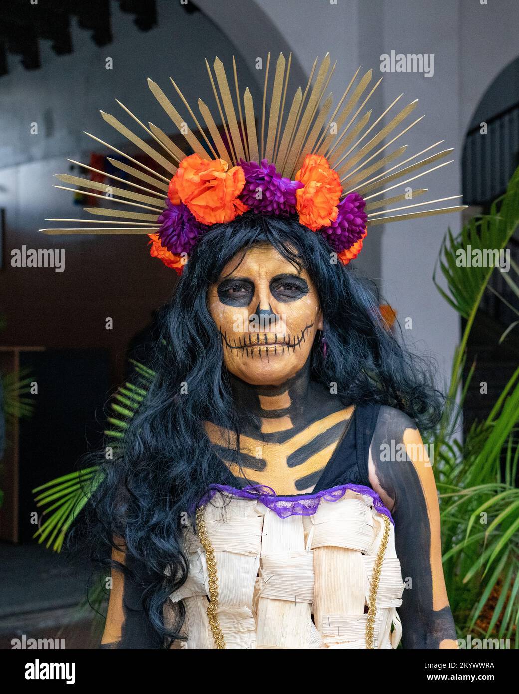 A woman with face painted and dressed for a costume competition for the Day of the Dead celebration in Oaxaca, Mexico. Stock Photo
