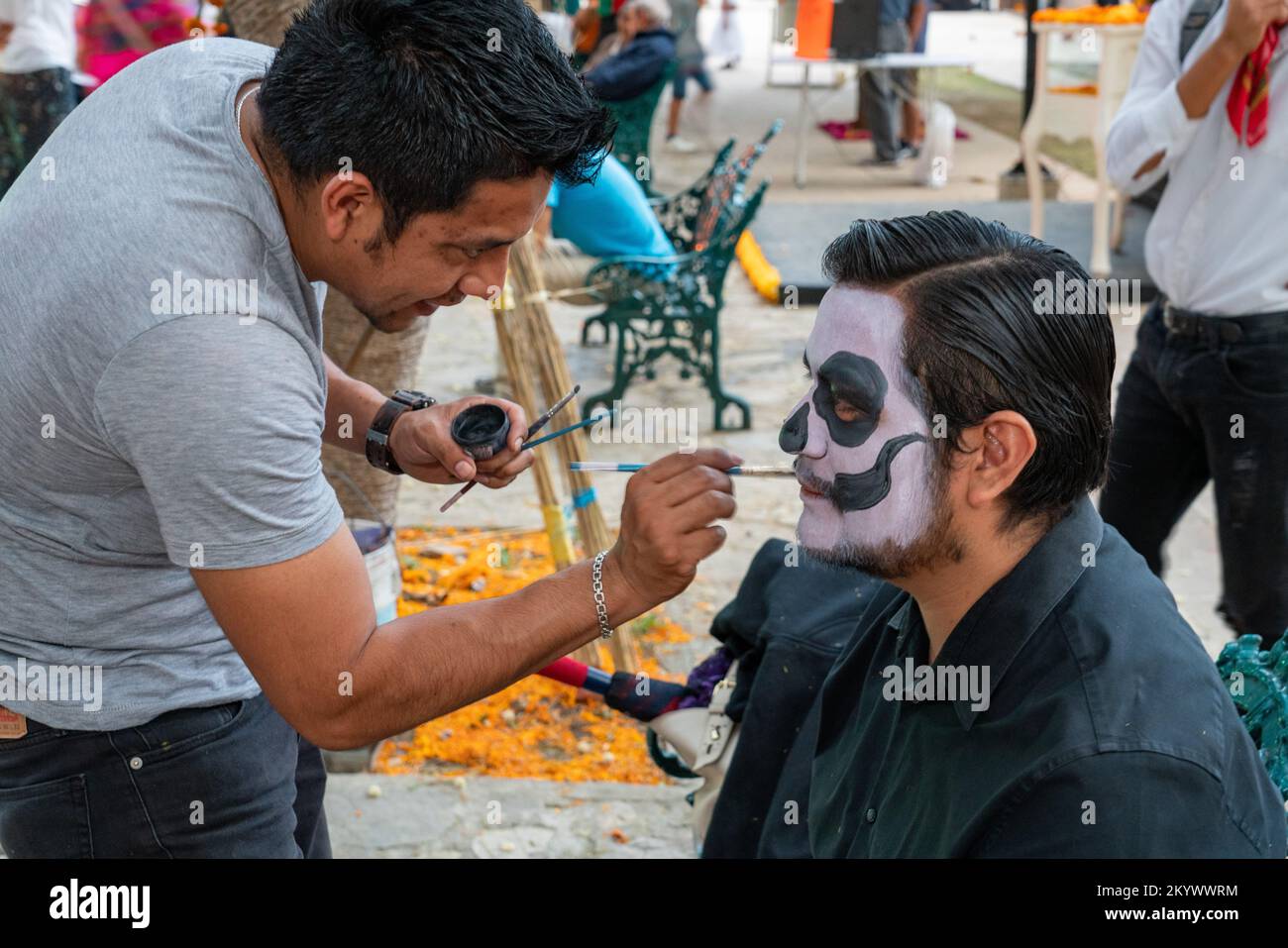 A man getting his face painted for the Day of the Dead celebration in Oaxaca, Mexico. Stock Photo