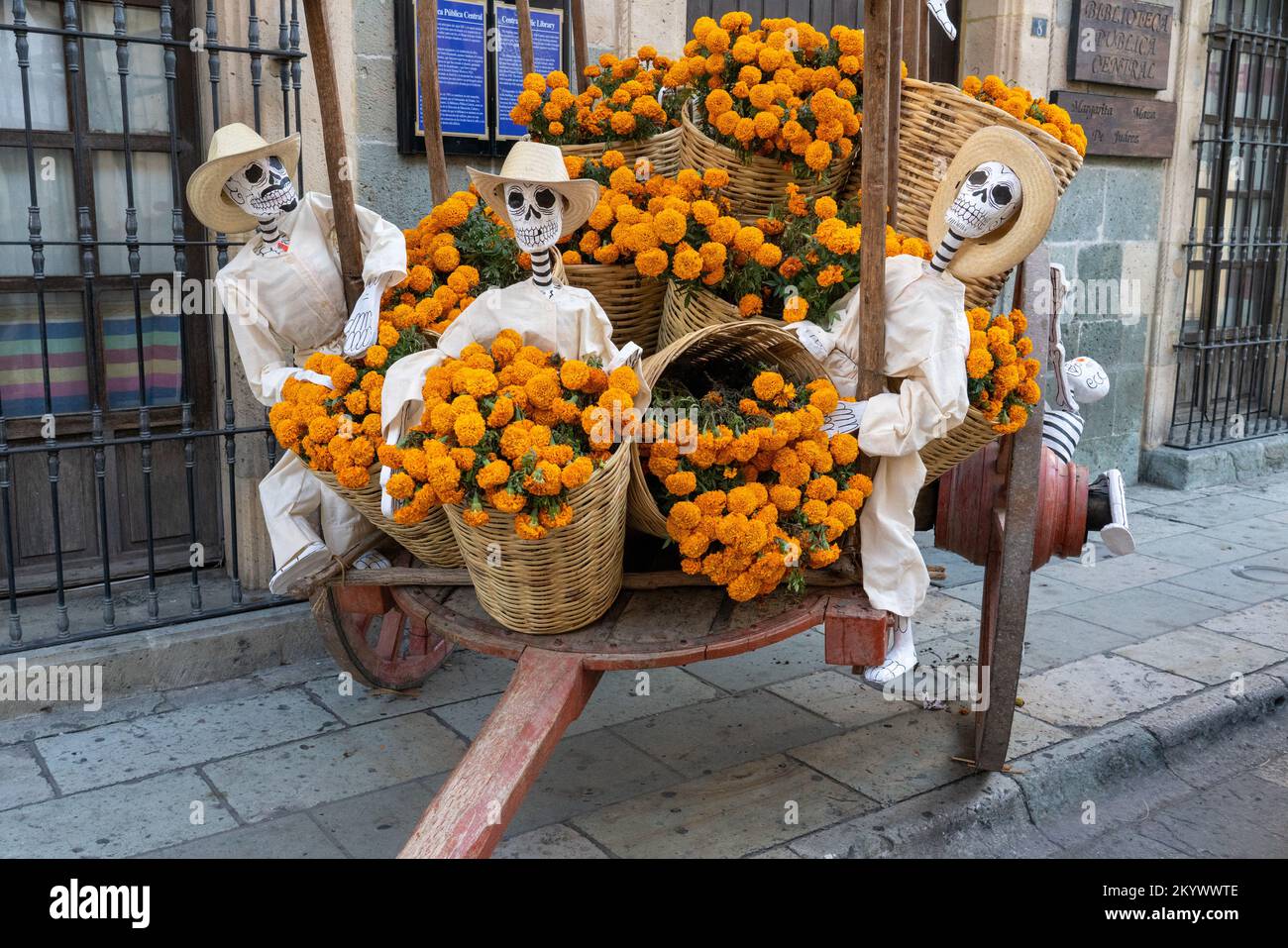 Mannequins dressed as campesinos on an oxcart with marigolds on the street for Day of the Dead in Oaxaca, Mexico. Stock Photo