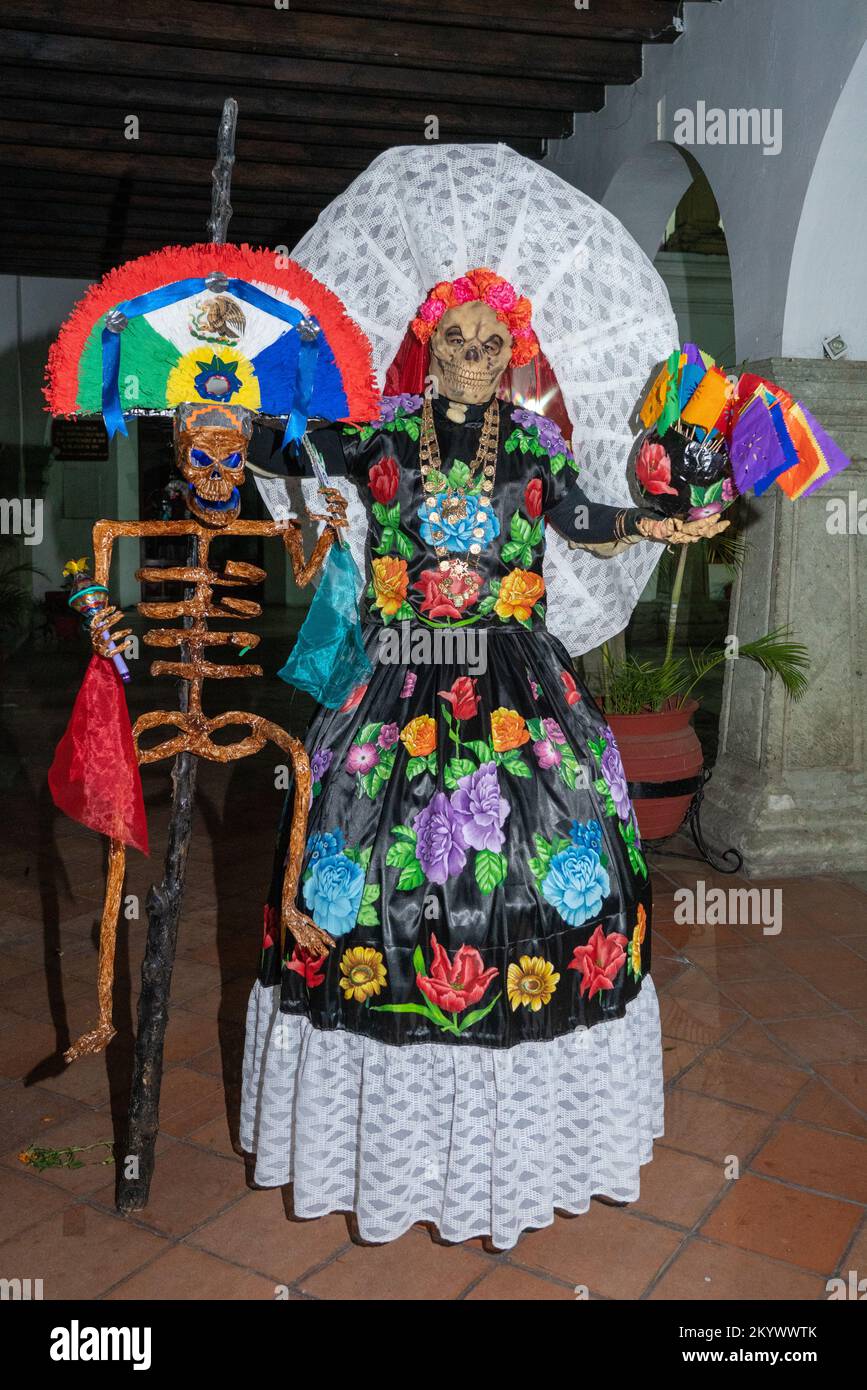 A person on stilts dressed in an Istmo-style dress for a costume competition for Day of the Dead celebration in Oaxaca, Mexico. Stock Photo
