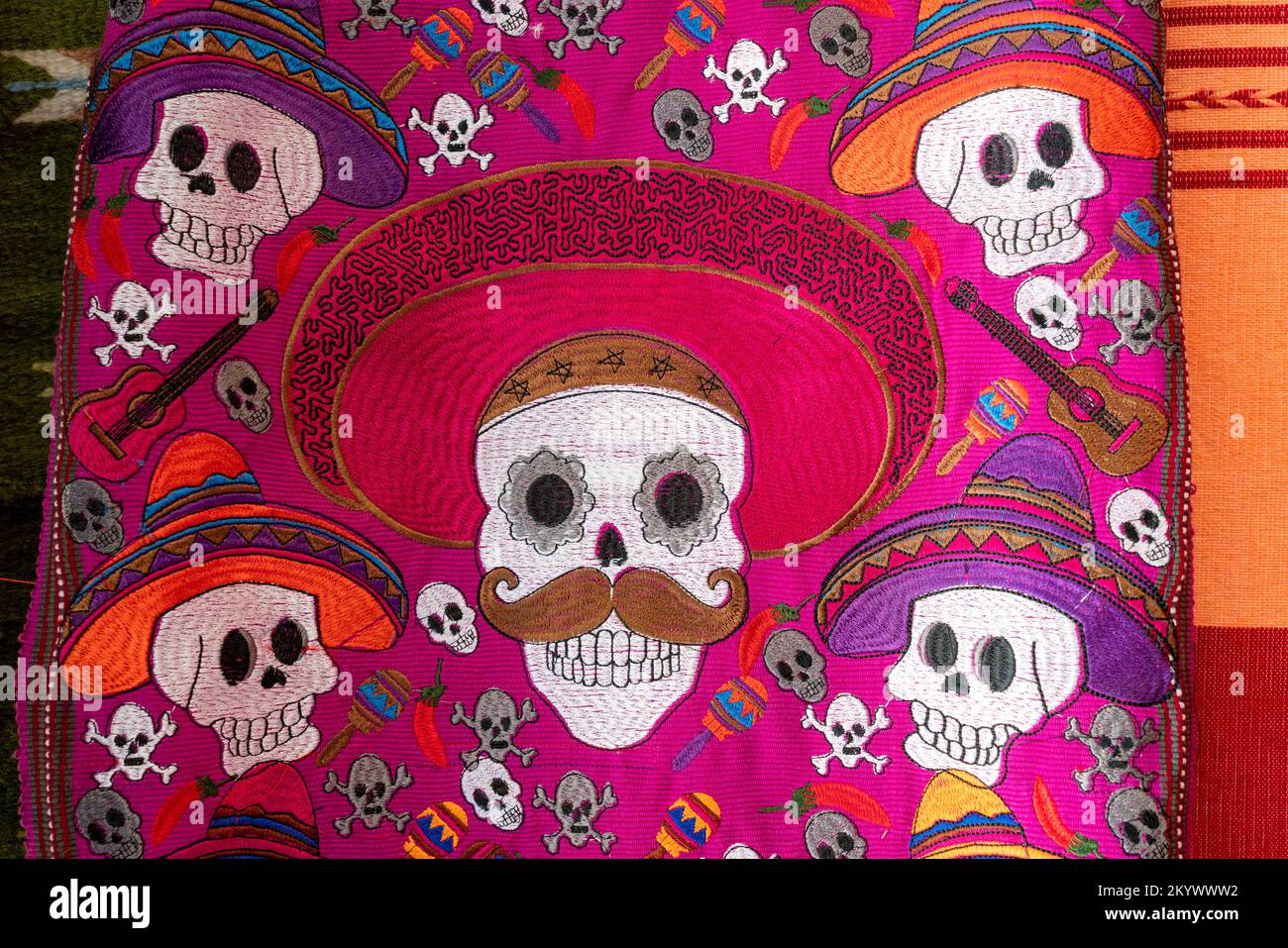 A woven wall-hanging with skulls for celebrating the Day of the Dead for sale in Oaxaca, Mexico. Stock Photo