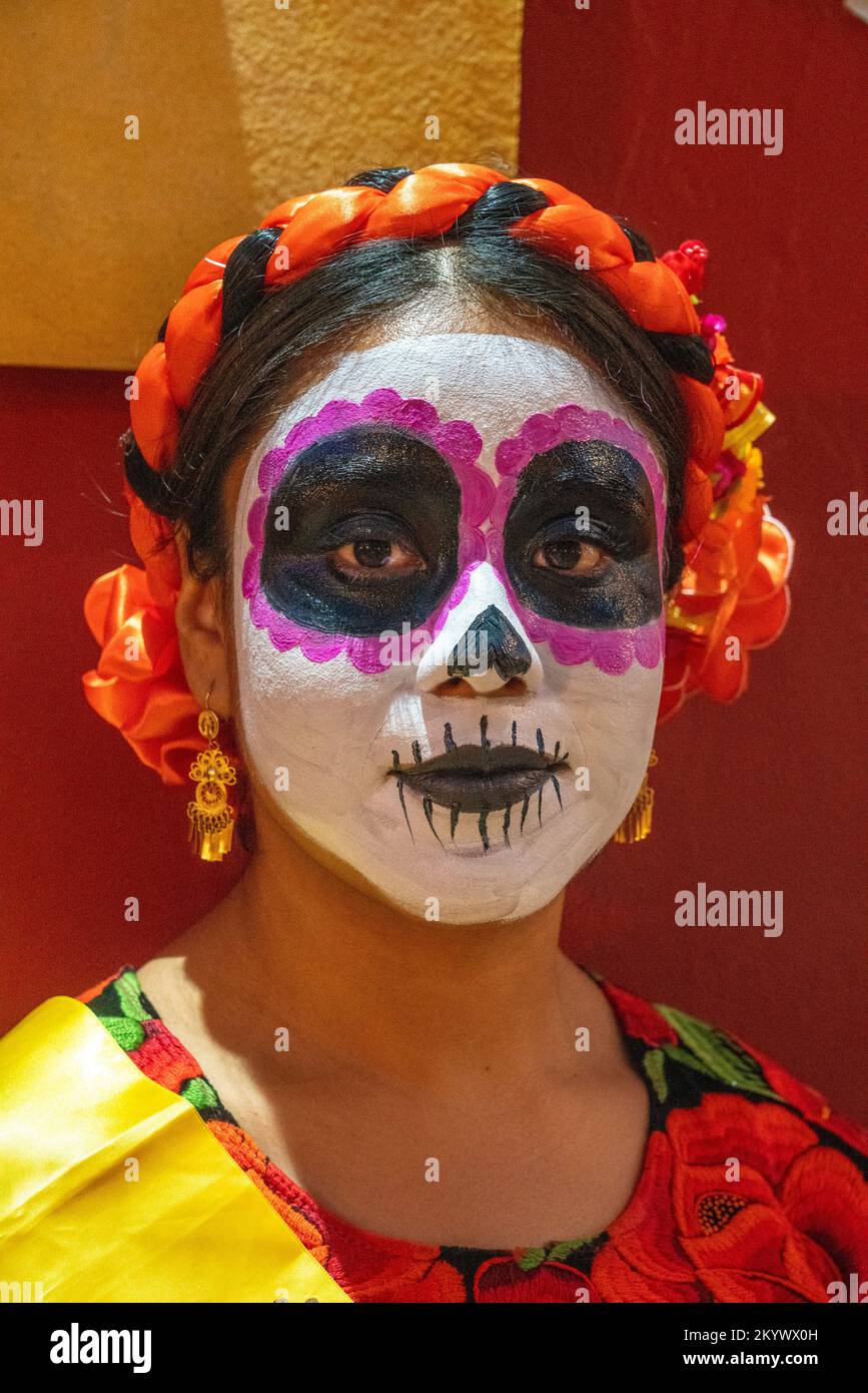a-young-woman-with-her-face-painted-for-the-day-of-the-dead-celebration