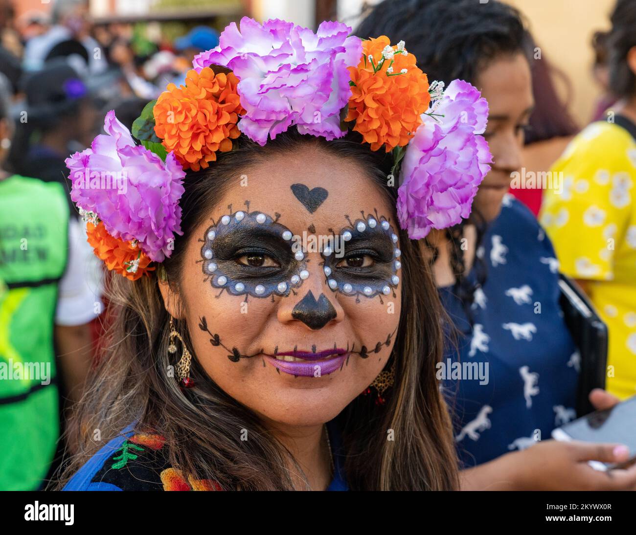 A young woman with her face painted for the Day of the Dead celebration in Oaxaca, Mexico. Stock Photo