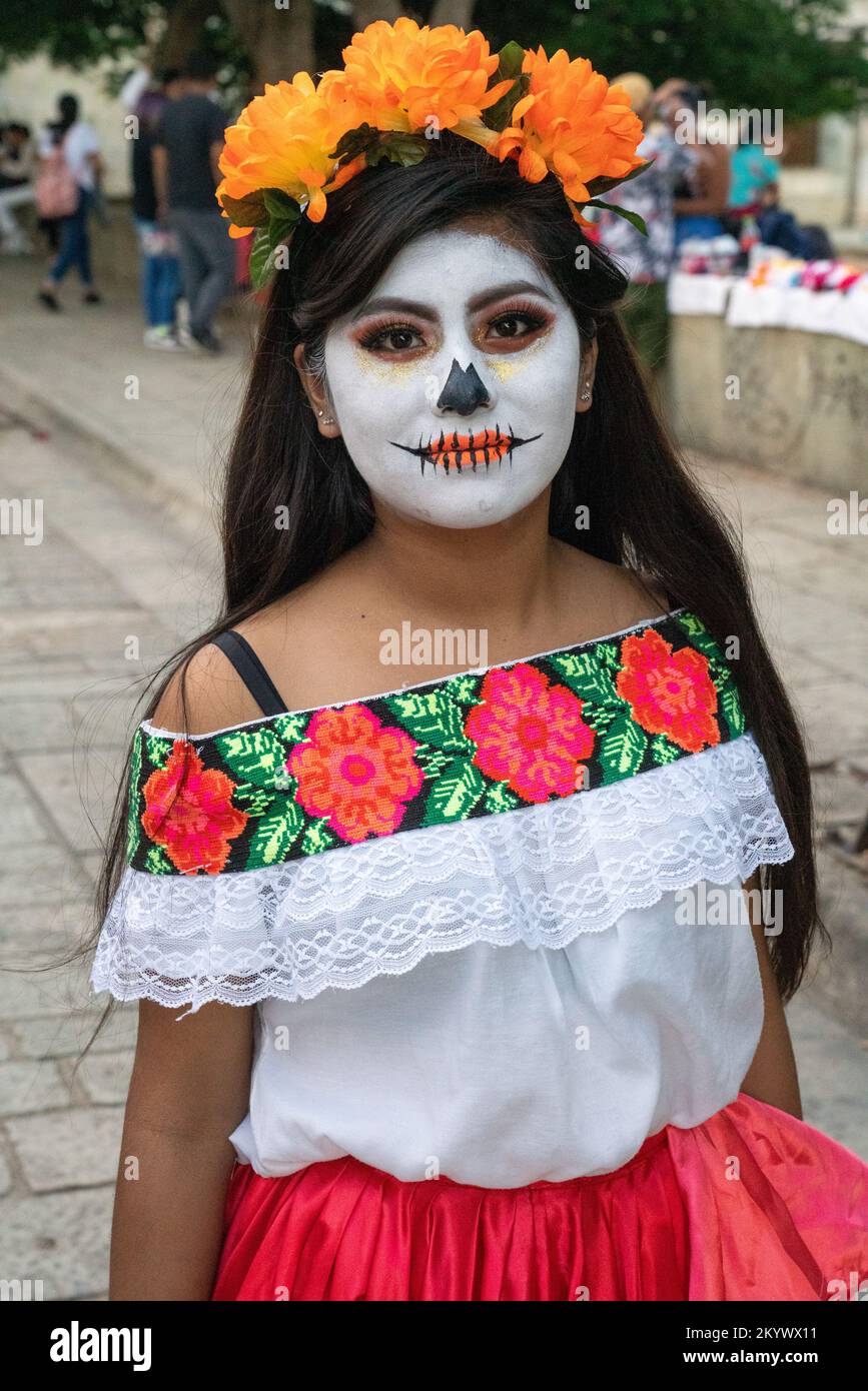 A young woman with her face painted for the Day of the Dead celebration in Oaxaca, Mexico. Stock Photo
