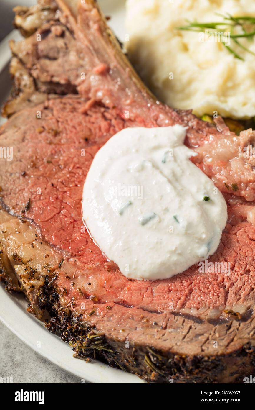 Homemade Standing Prime Rib Beef Roast with Horseradish Sauce and Potatoes Stock Photo