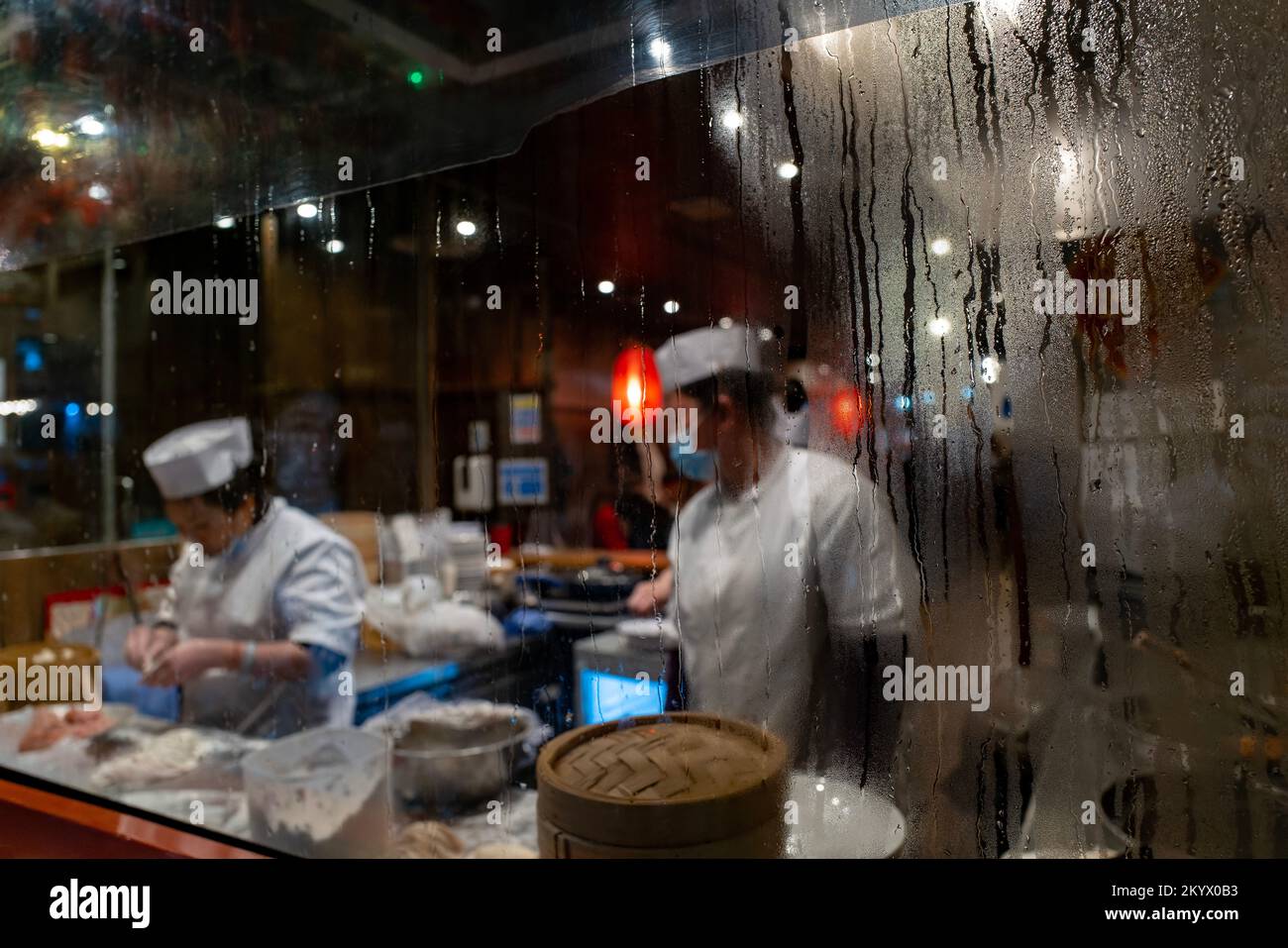 Chefs working in a steamed up restaurant in Chinatown, Soho, London Stock Photo