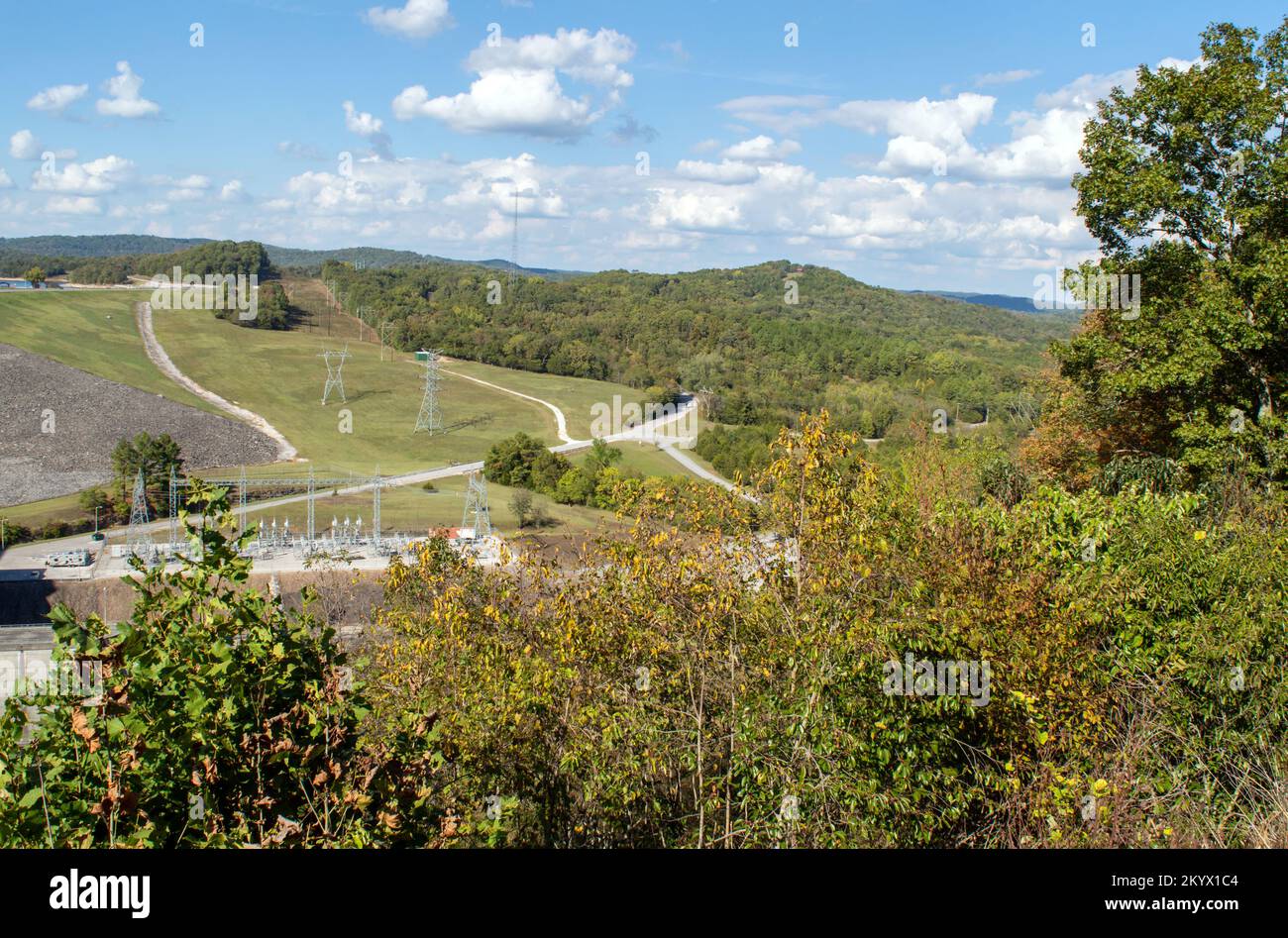 The blue sky, green trees, Arkansas dam and meandering roads makes a peaceful view from high above. A nice spot for admiring nature and man made struc Stock Photo