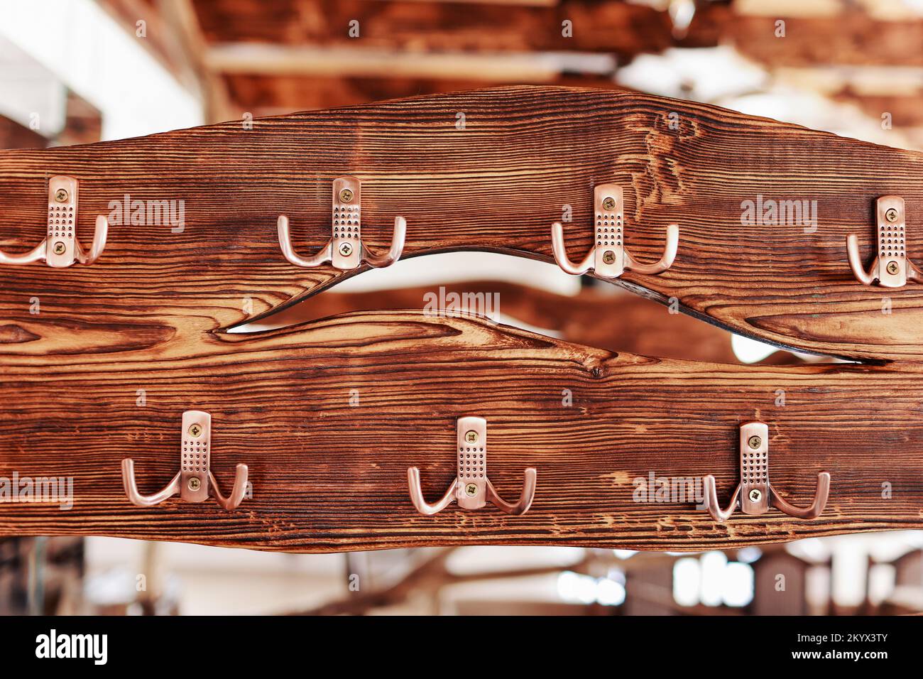 A rustic wooden board with metal hooks. Clothes hanger gold steel hooks ...