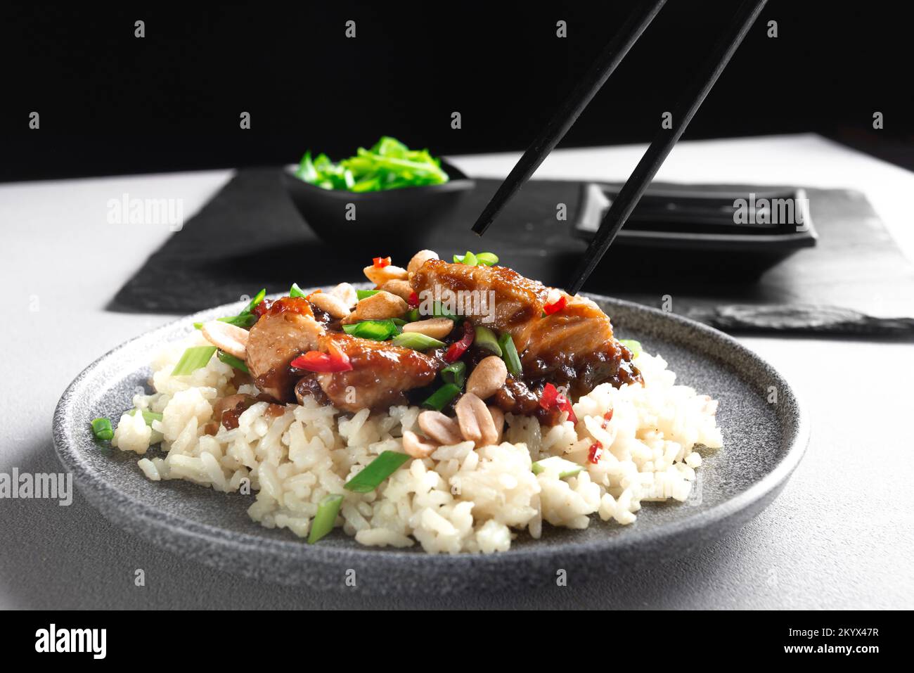 Asian food. Asian food eaten with chopsticks. Kung Pao Chicken and Rice. Kung Pao Chicken or
