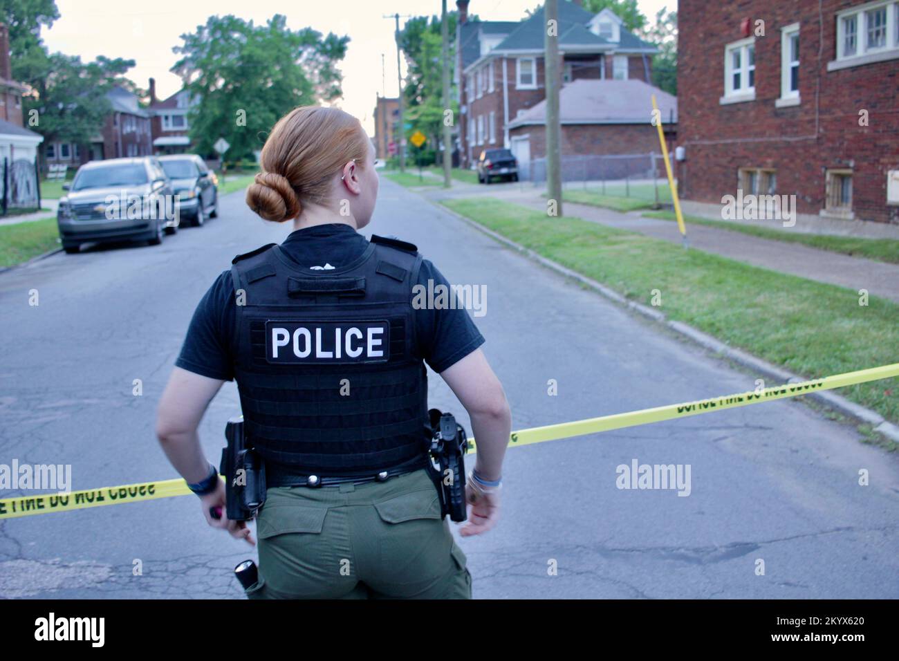 A Detroit police Special Ops officer stands guard over a crime scene