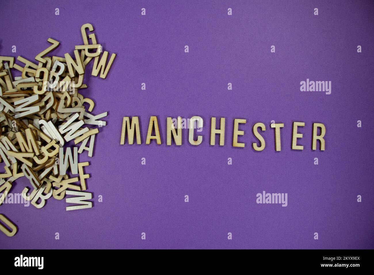 pile of wooden English language capital letters spilling into words