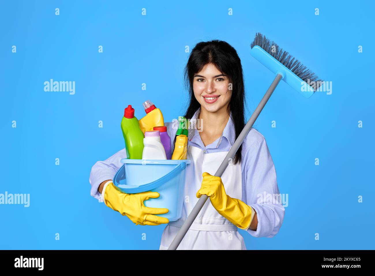 woman in gloves holding bucket of detergents and broom Stock Photo - Alamy