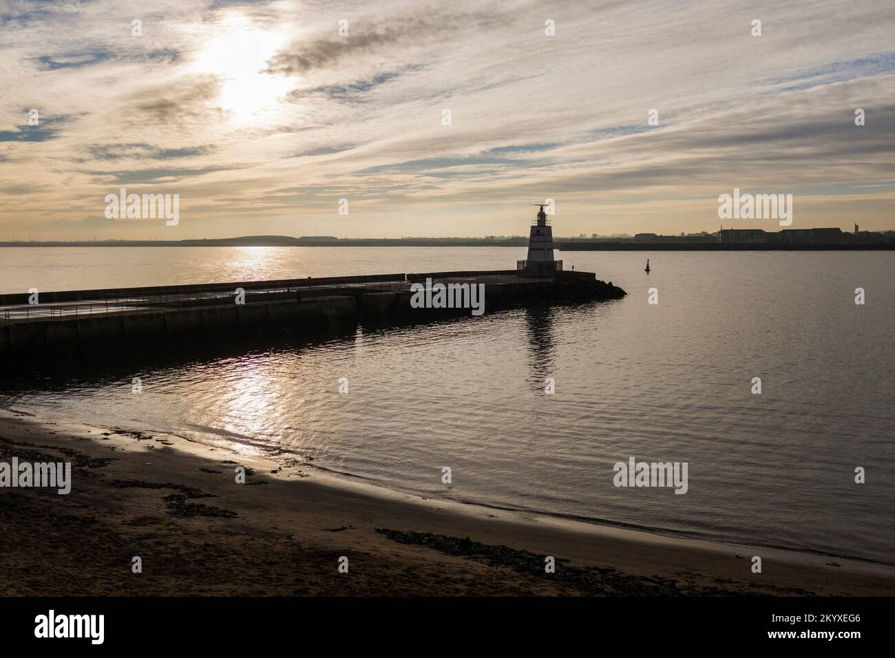 Sunset casting a reflection across the water by the pier  at Hartlepool Headland,England,UK Stock Photo