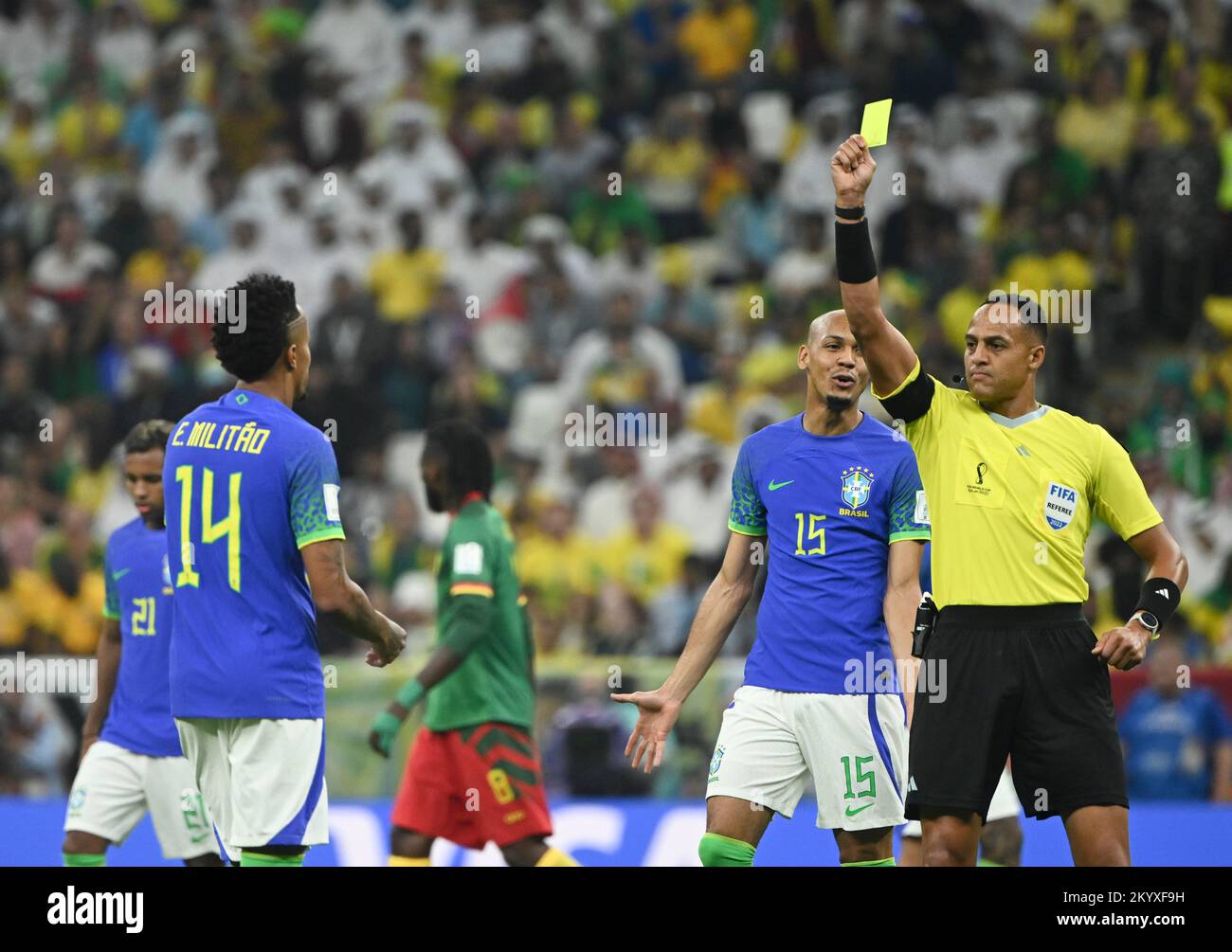 Lusail, Qatar. 2nd Dec, 2022. Referee Ismail Elfath (R) gives a yellow card to Eder Militao of Brazil during the Group G match between Cameroon and Brazil at the 2022 FIFA World Cup at Lusail Stadium in Lusail, Qatar, Dec. 2, 2022. Credit: Li Ga/Xinhua/Alamy Live News Stock Photo