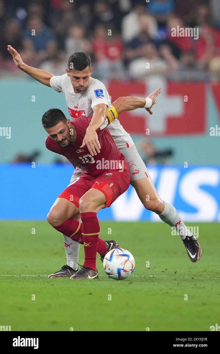Doha, Qatar. 2nd Dec, 2022. Dusan Tadic (bottom) of Serbia vies with Remo Freuler of Switzerland during their Group G match at the 2022 FIFA World Cup at Stadium 974 in Doha, Qatar, Dec. 2, 2022. Credit: Zheng Huansong/Xinhua/Alamy Live News Stock Photo