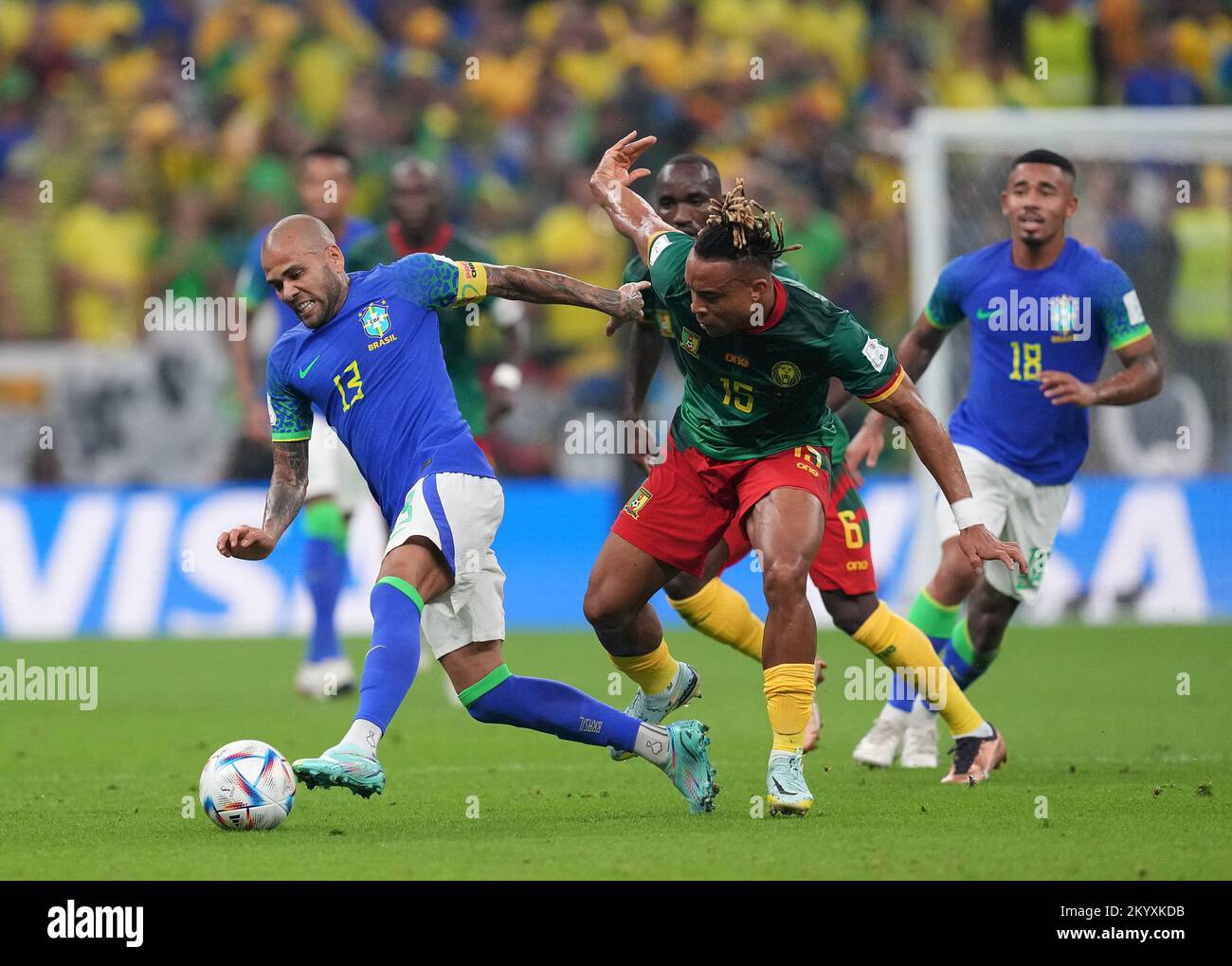 Brazil's Dani Alves (left) and Cameroon's Pierre Kunde battle for the ball during the FIFA World Cup Group G match at the Lusail Stadium in Lusail, Qatar. Picture date: Friday December 2, 2022. Stock Photo