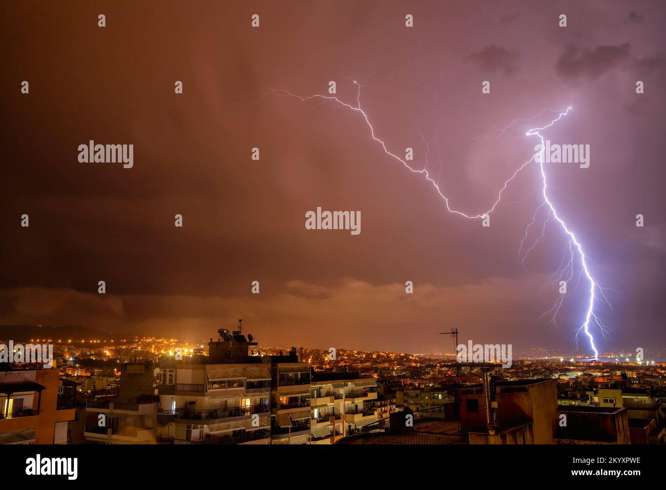 night city view under thunderstorm with strike of lightning. Powerful