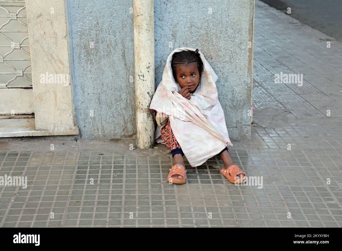 Young child alone on the street asking for food in Eritrea Stock Photo