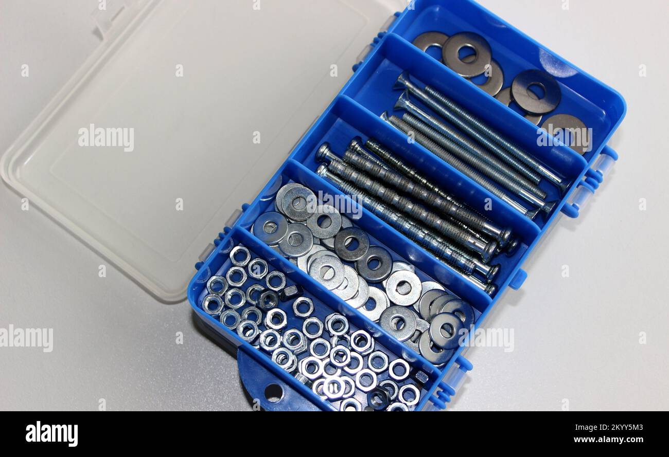 Box With Compartments For Screw Bolts, Hex Nuts And Steel Washers With Open Plastic Lid Stock Photo