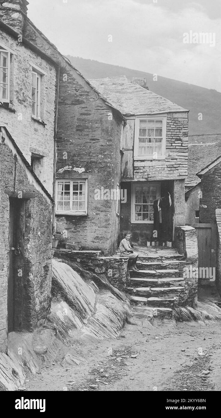 Vintage photograph - 1924 - Gorl on steps of Old Smuggler's Cottage, Polperro, Cornwall Stock Photo
