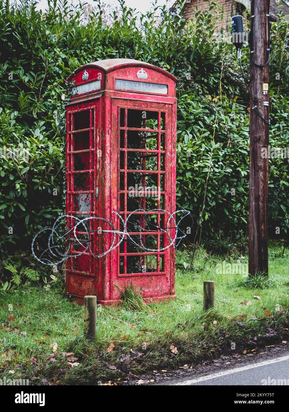 Razor wire around a classic red telephone box Stock Photo Alamy