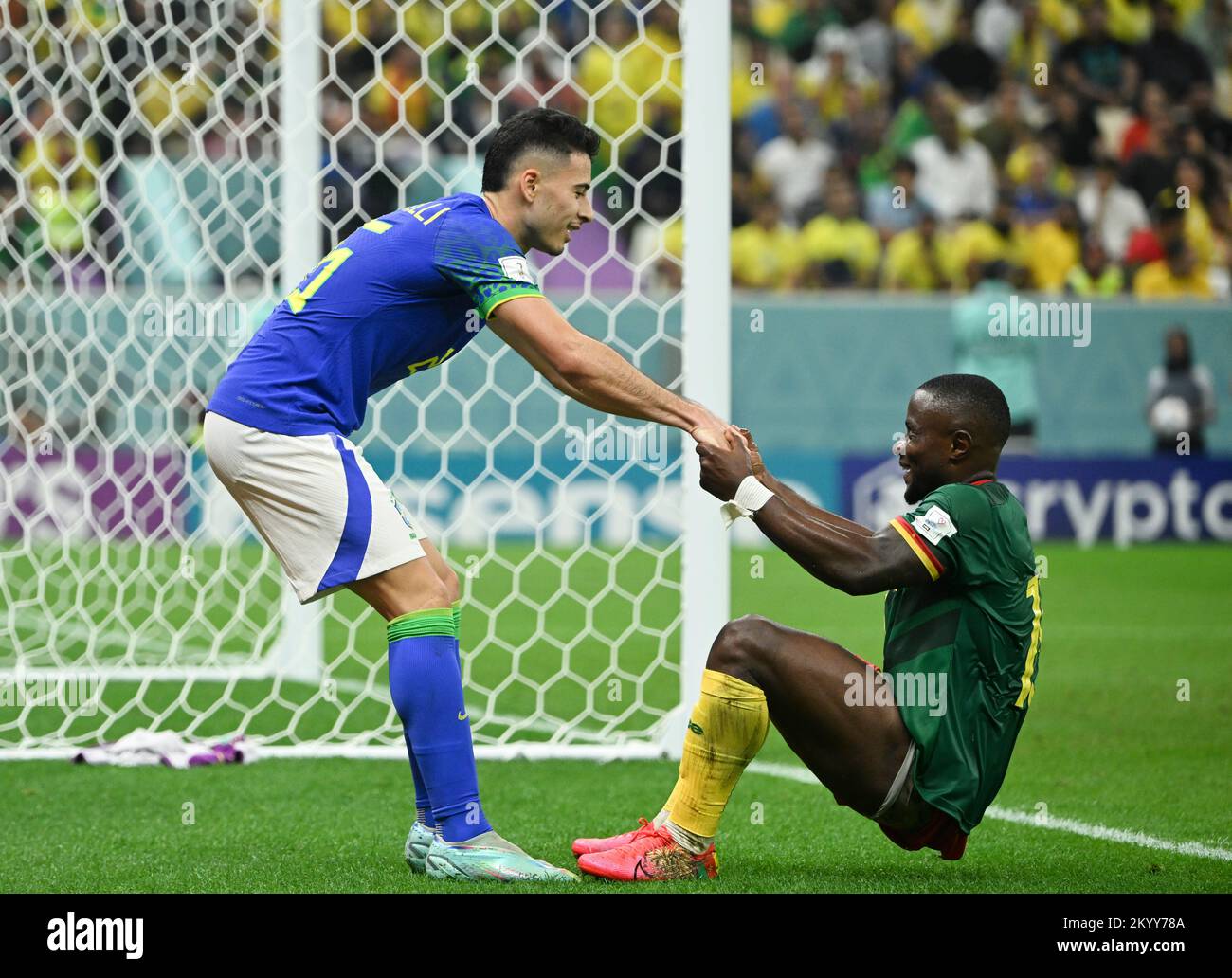 Lusail, Qatar. 2nd Dec, 2022. Gabriel Martinelli of Brazil helps Collins Fai of Cameroon get up during their Group G match at the 2022 FIFA World Cup at Lusail Stadium in Lusail, Qatar, Dec. 2, 2022. Credit: Li Ga/Xinhua/Alamy Live News Stock Photo