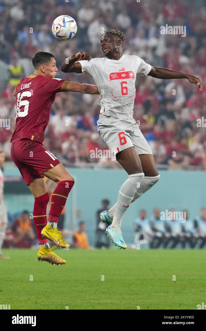 Doha, Qatar. 2nd Dec, 2022. Denis Zakaria (R) of Switzerland vies for a header with Sasa Lukic of Serbia during the Group G match between Serbia and Switzerland at the 2022 FIFA World Cup at Stadium 974 in Doha, Qatar, Dec. 2, 2022. Credit: Meng Dingbo/Xinhua/Alamy Live News Stock Photo