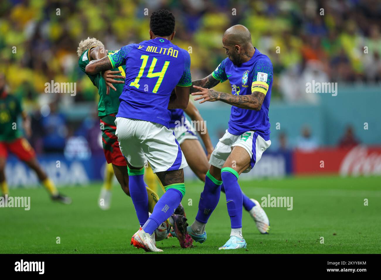 Lusail City, Qatar. 02nd Dec, 2022. Eric Maxim Choupo-Moting of Cameroon, Eder Militão e Dani Alves of Brazil during the FIFA World Cup Qatar 2022 Group G match between Cameroon and Brazil at Lusail Stadium in Lusail City, Qatar. December 2. Credit: Brazil Photo Press/Alamy Live News Stock Photo