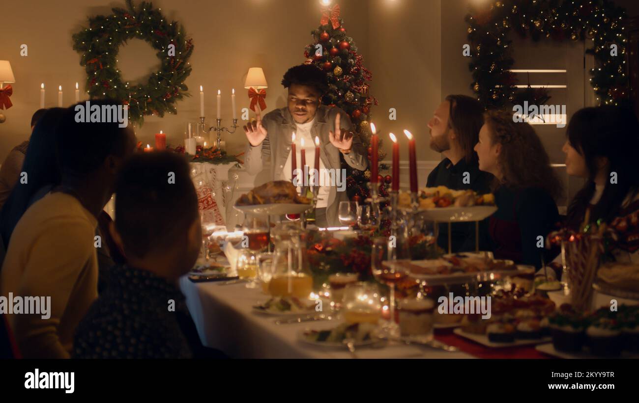 African American man givs gift to young boy. Happy family celebrating