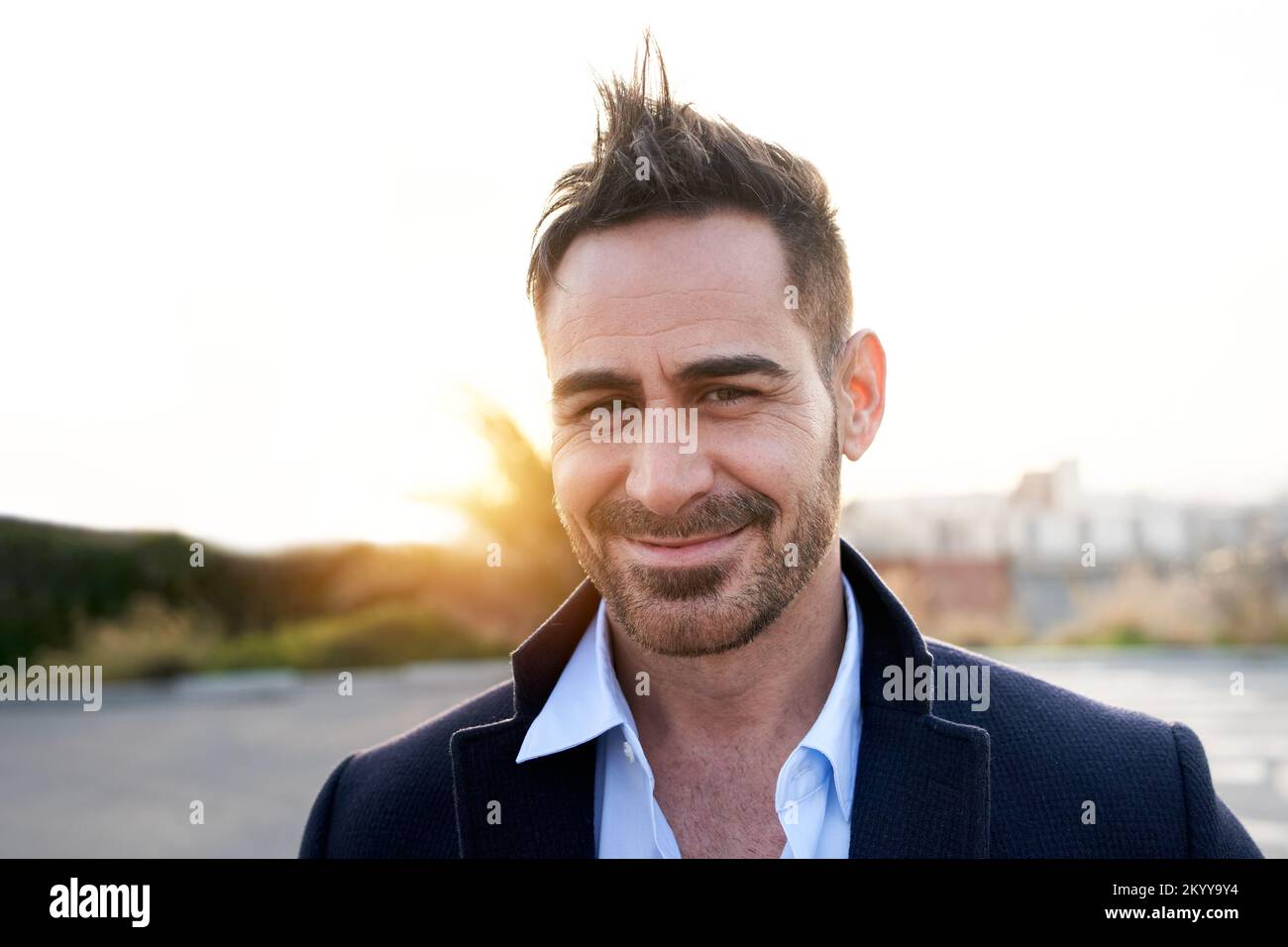 Portrait of a handsome mature man looking at the camera outdoors. Spanish person with nice smile Stock Photo