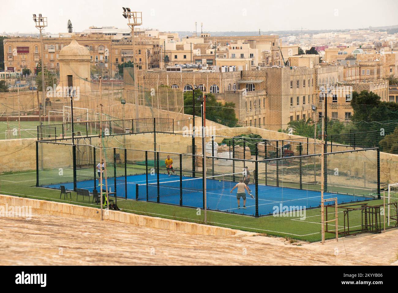 Valletta, Malta - November 12, 2022: 16th century  fortification with the paddle tennis court and a football pitch,  and view of Floriana town, from t Stock Photo