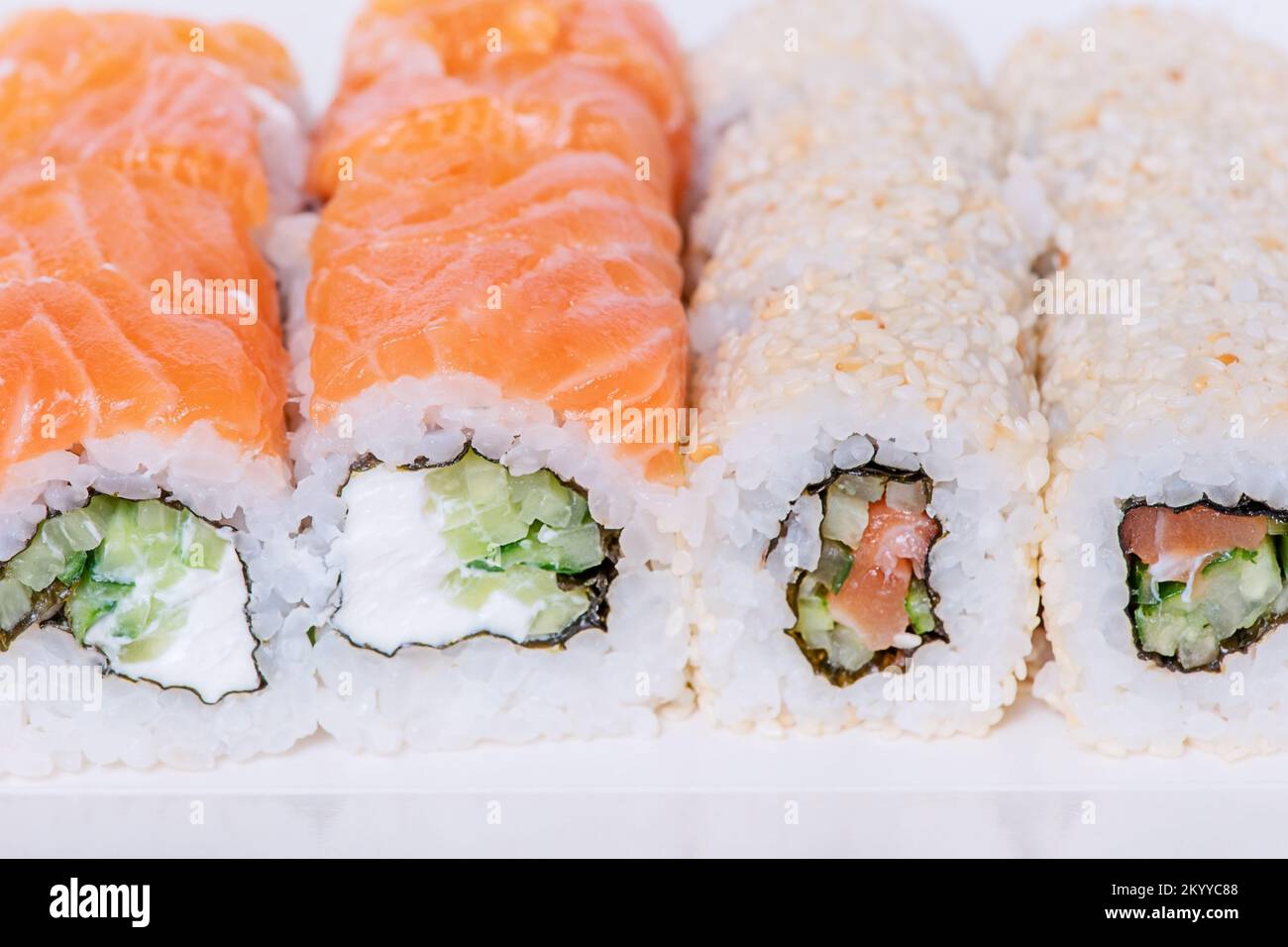 Food delivery. Japanese food rolls in sesame with salmon, cucumber