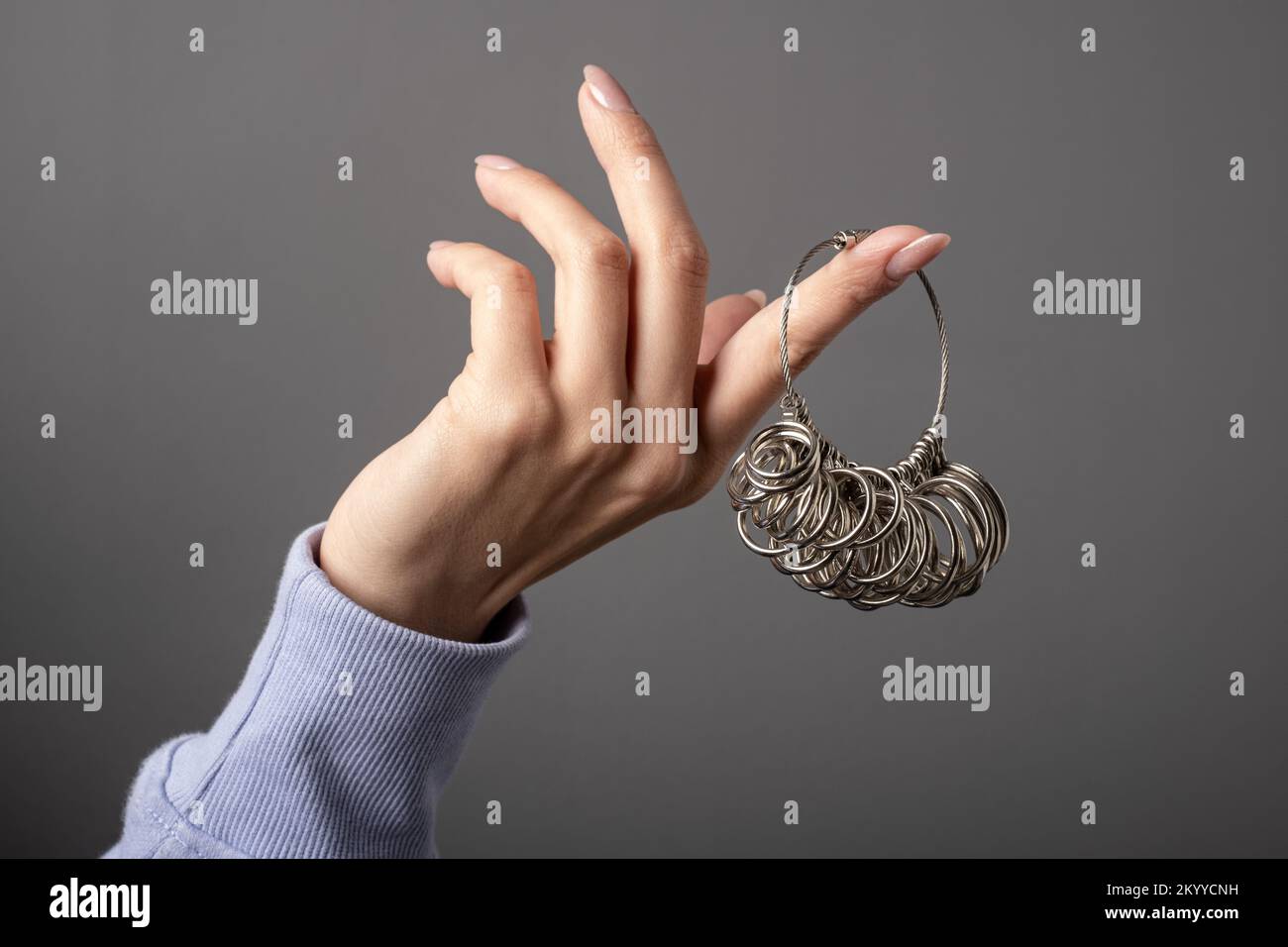 Finger Sizing Gauge Rings Measurement .Woman hand holding Ring Sizer