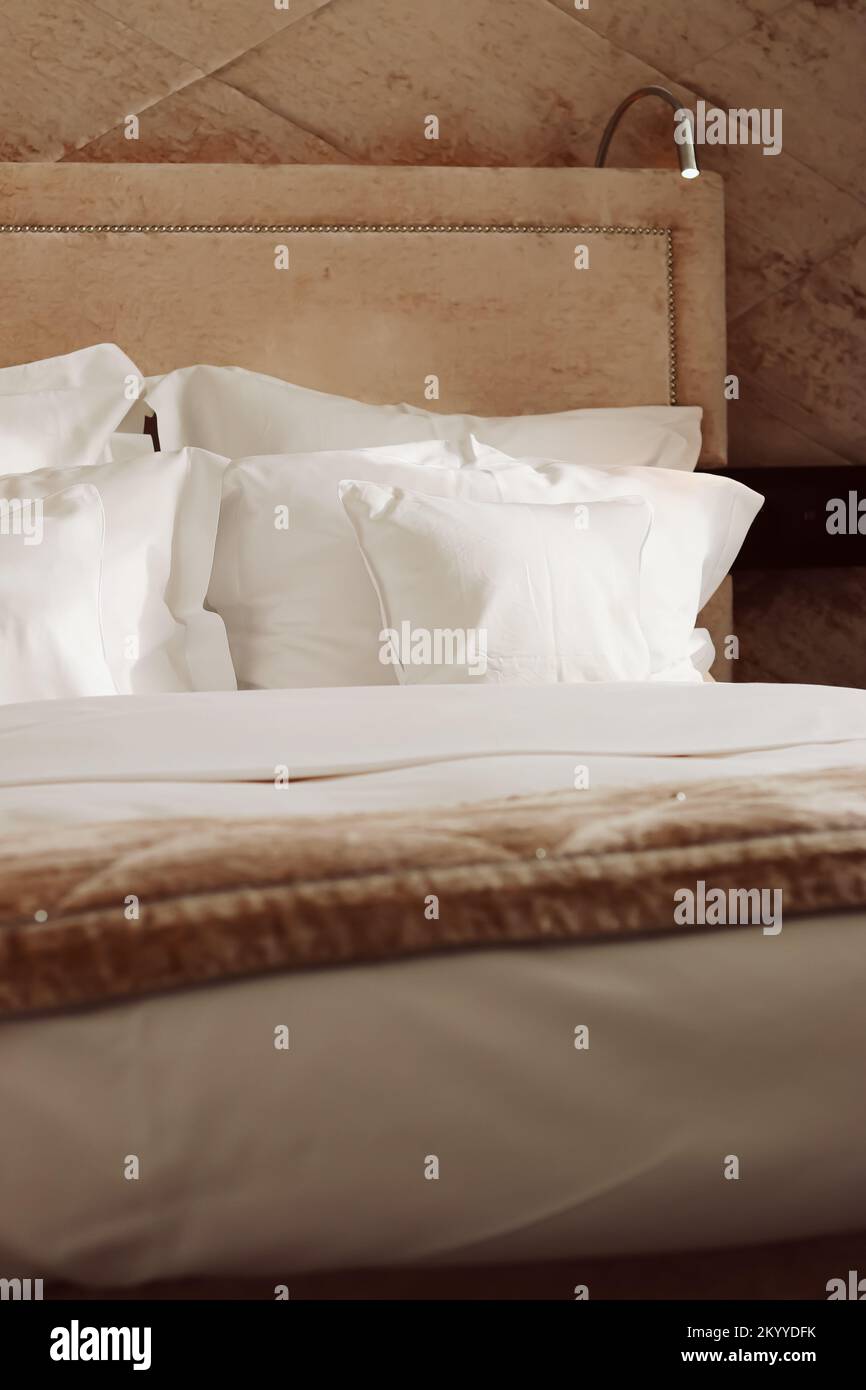 Home decor and interior design, bed with white bedding in luxury
