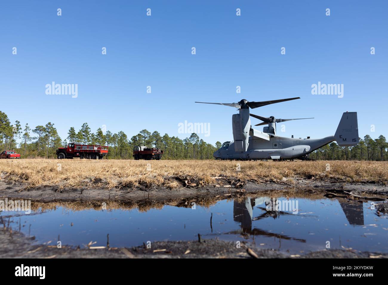 Fire and Emergency Services Vehicles are parked next to an MV22 Osprey