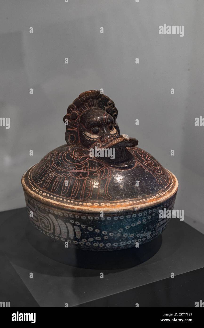 Ceramic Maya vessel depicting a cormorant eating a fish from the Early classic period. Campeche, Mexico. Stock Photo