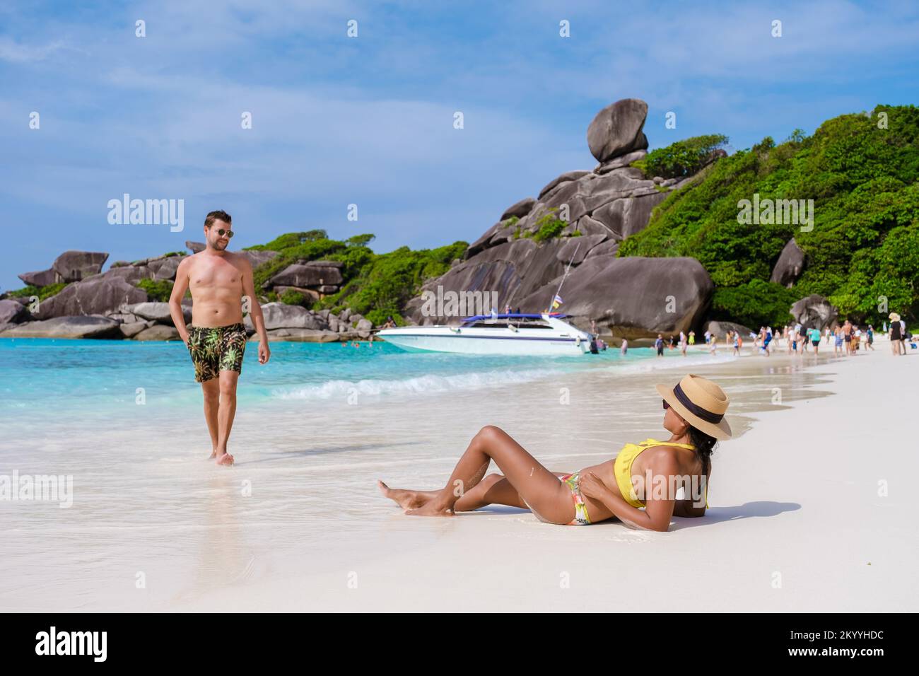 Caucasian men and black women are relaxing on a tropical beach in Thailand, Similan Islands.  Stock Photo
