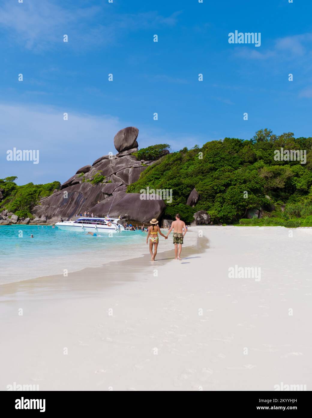 men and women walking at a white tropical beach in Thailand Similan Islands Phangnga.  Stock Photo