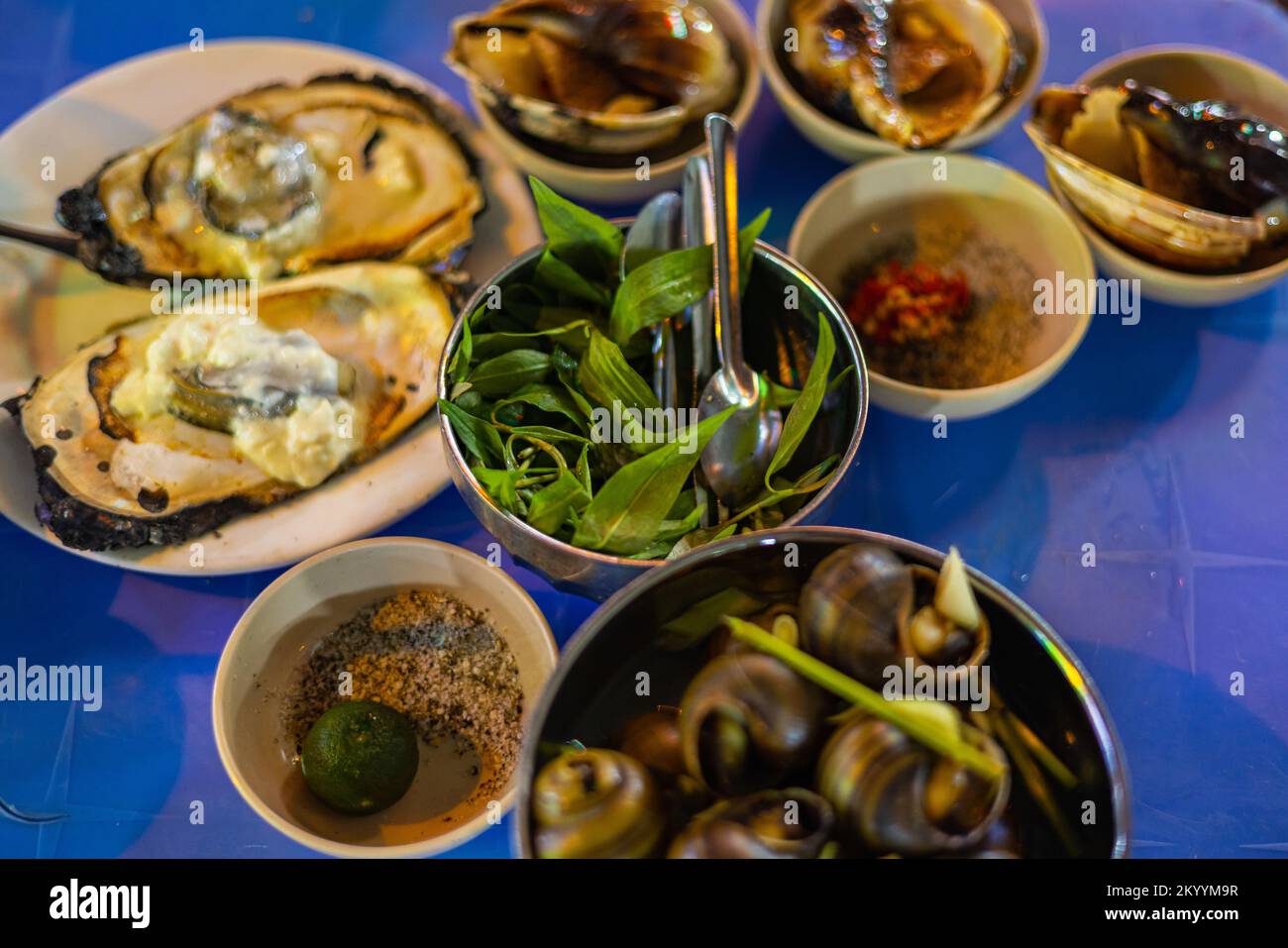 Street food dishes in the streets of Saigon. Mussels, snails and