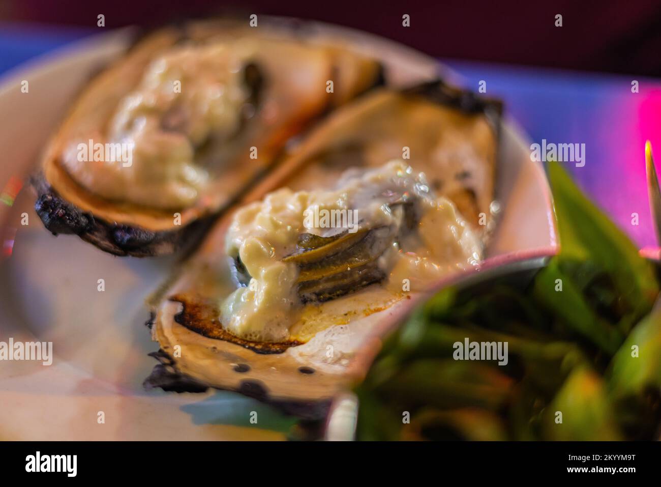 Street food dishes in the streets of Saigon. Mussels, snails and