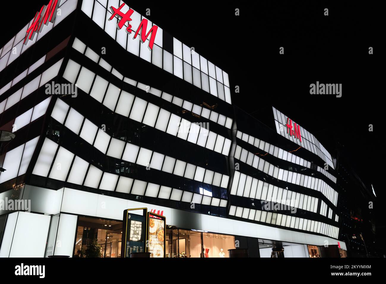Beijing,China-September 14th 2022: large H&M clothing flagship store at TaiKoo Li Sanlitun at night. Fast fashion brand Stock Photo