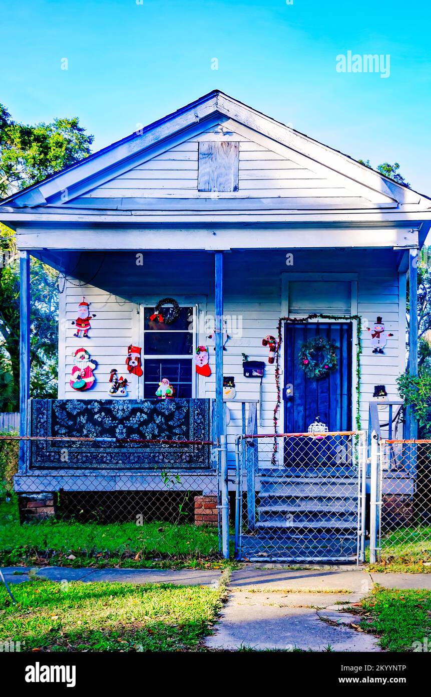 A shotgun house is decorated for Christmas, Nov. 30, 2022, in Mobile, Alabama. Shotgun houses are an architectural style in the American South. Stock Photo