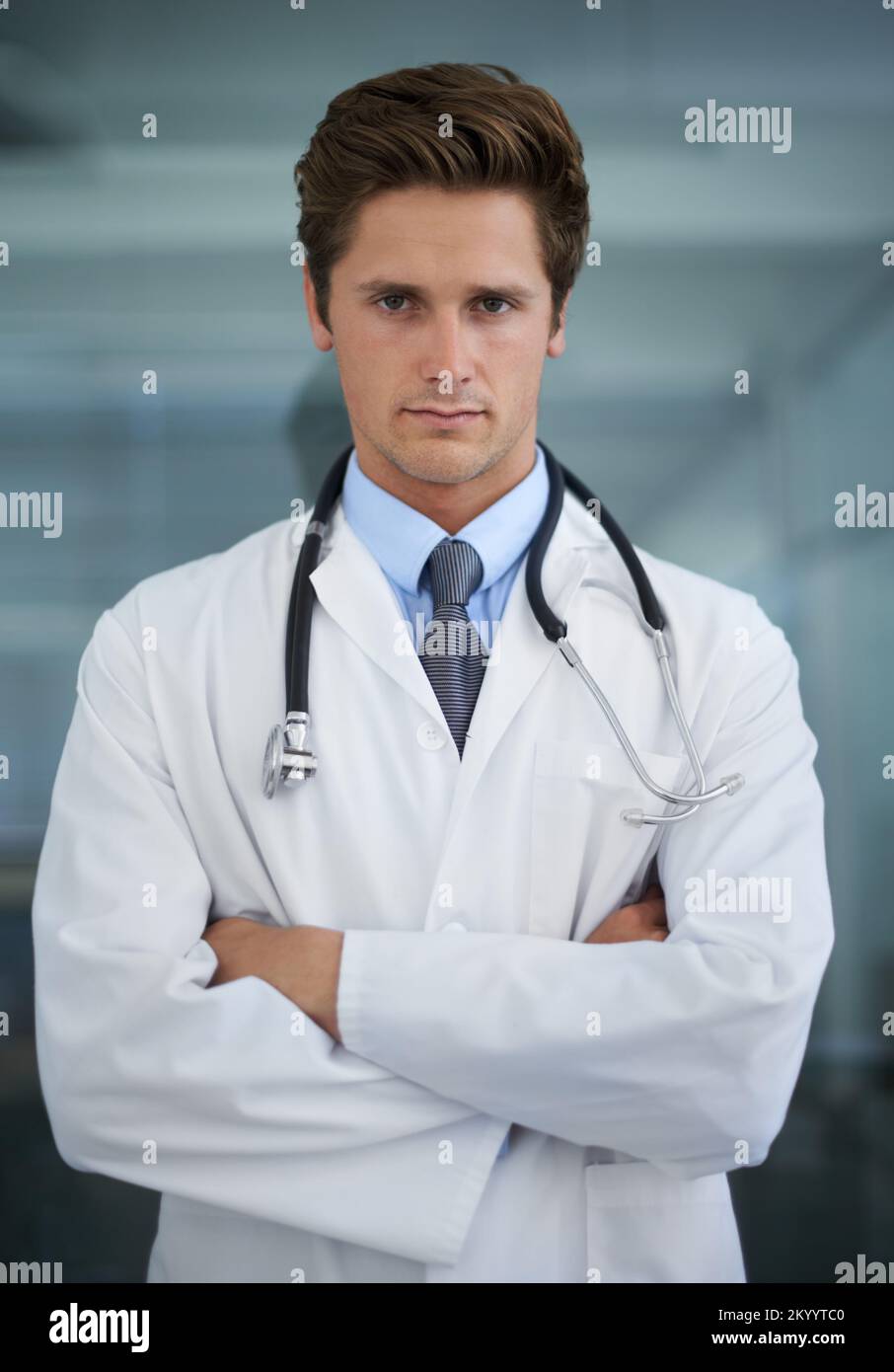 Serious about your health. Portrait of a serious-looking young doctor standing with his arms folded. Stock Photo