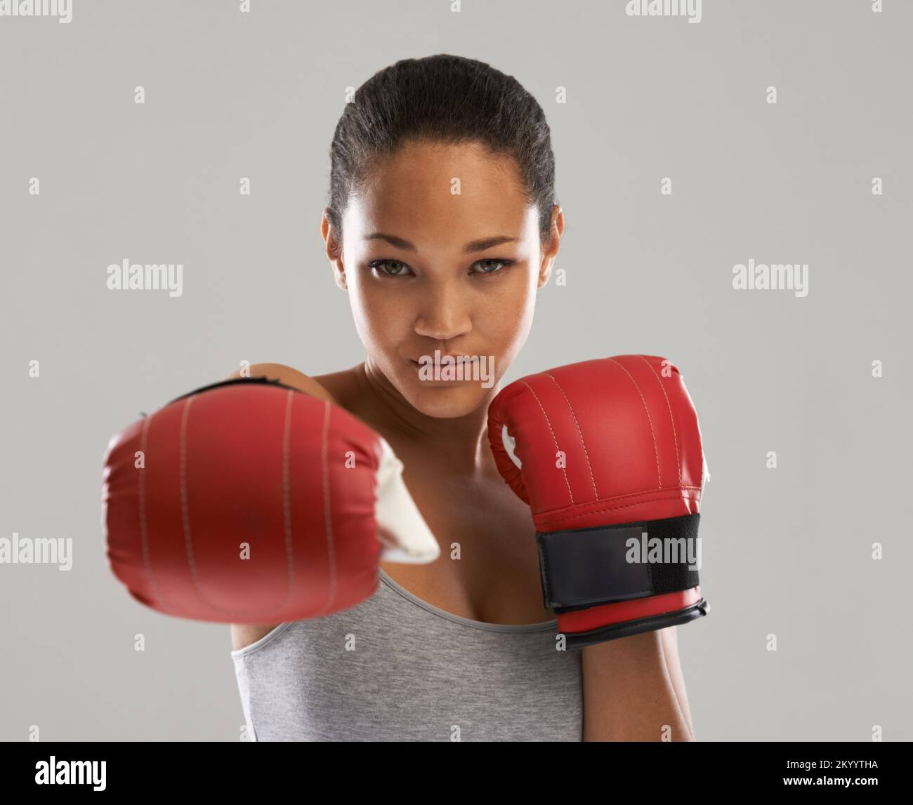 Punching weightgain in the face. A beautiful young woman wearing