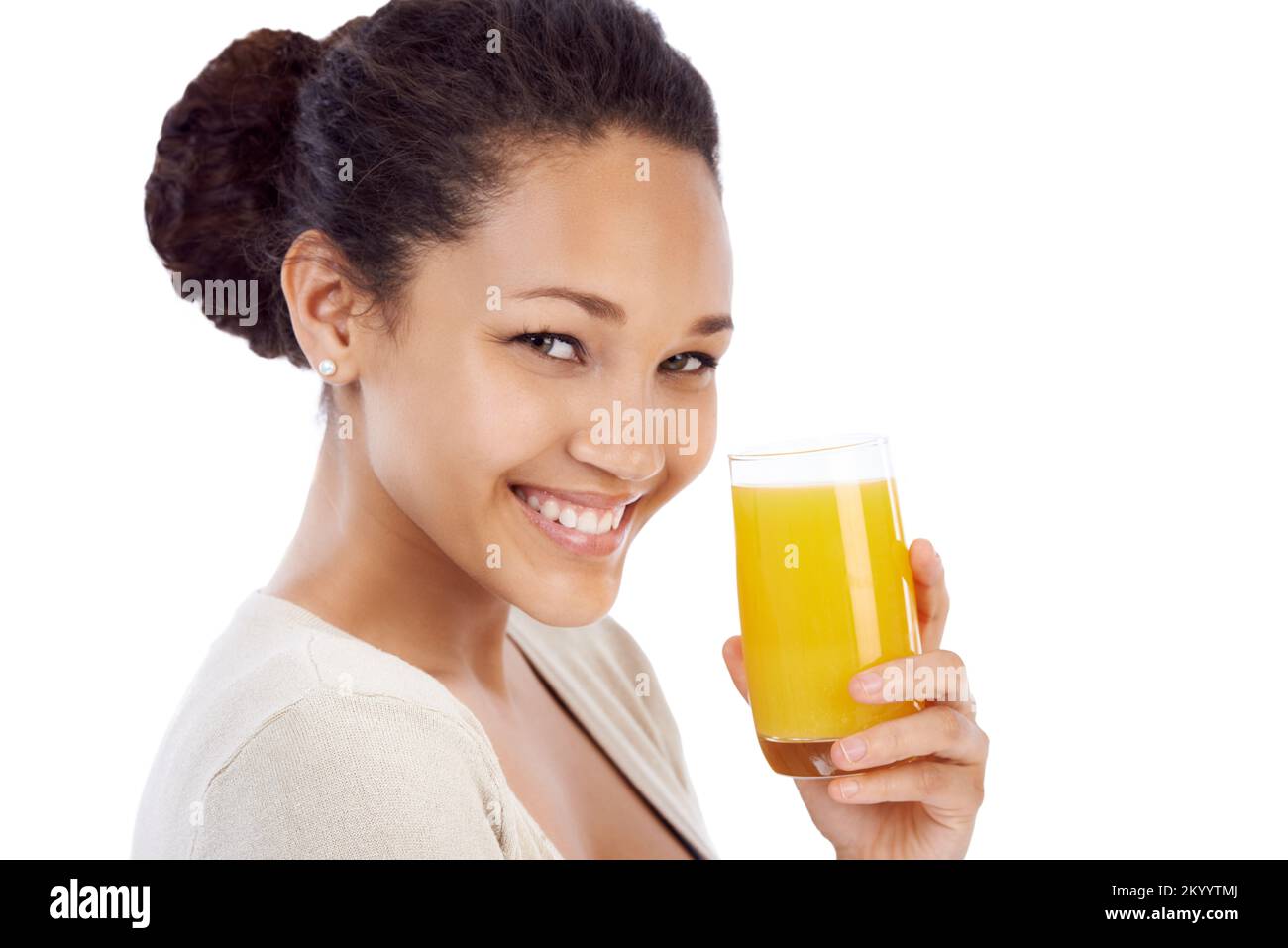 Getting her daily dose of vitamin C. Young woman smiling while drinking