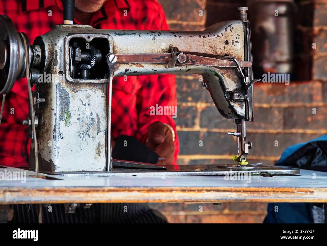 Midsection of a man sewing on an old sewing machine in Kathmandu, Nepal Stock Photo