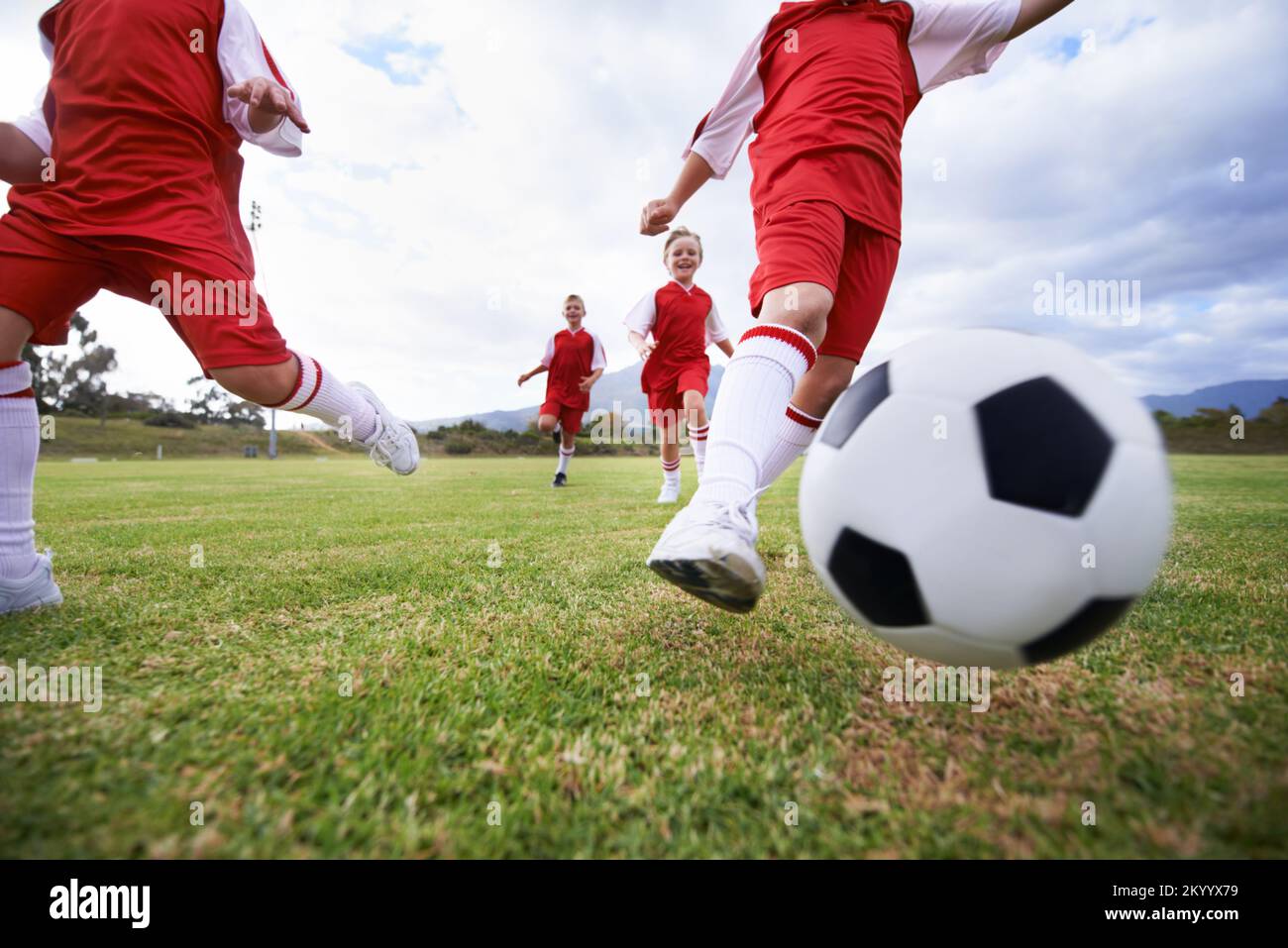 Learning teamwork while playing together. Low angle of kids playing