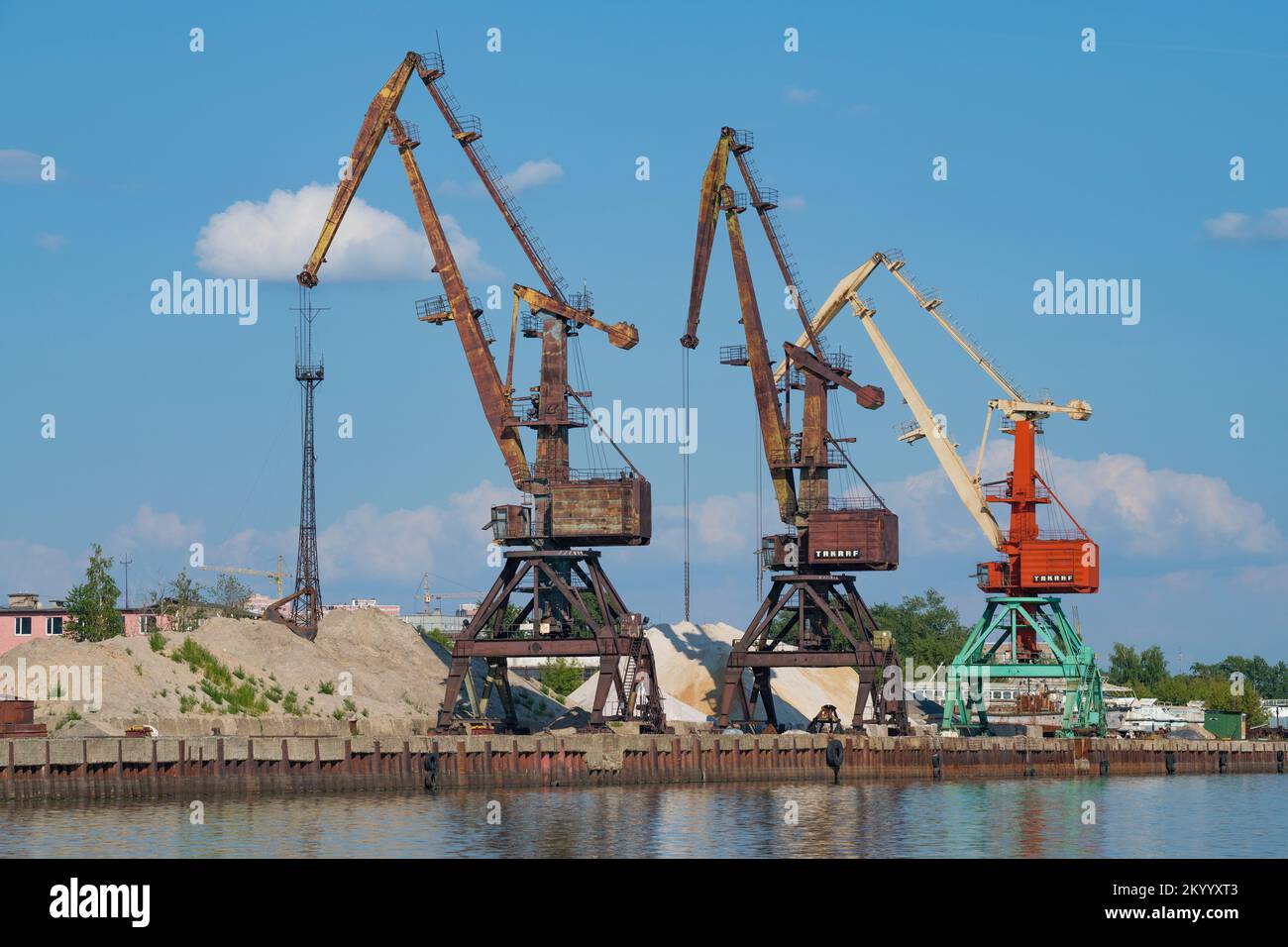 CHEREPOVETS, RUSSIA - AUGUST 04, 2022: Three port cranes in the river port on a sunny summer day Stock Photo
