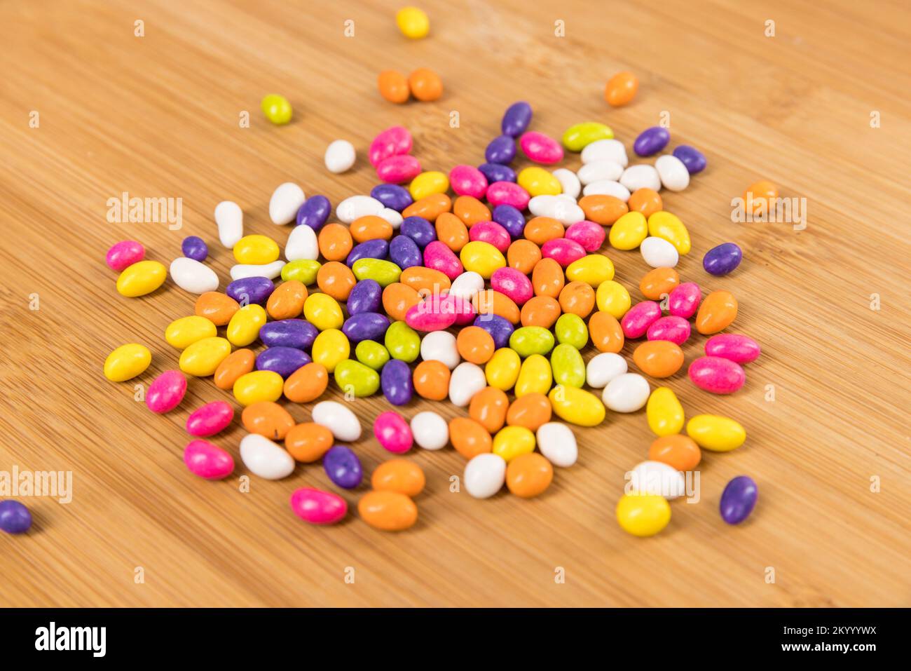 Fennel seed candy in a pile on a wood cutting board top down view Stock Photo Alamy