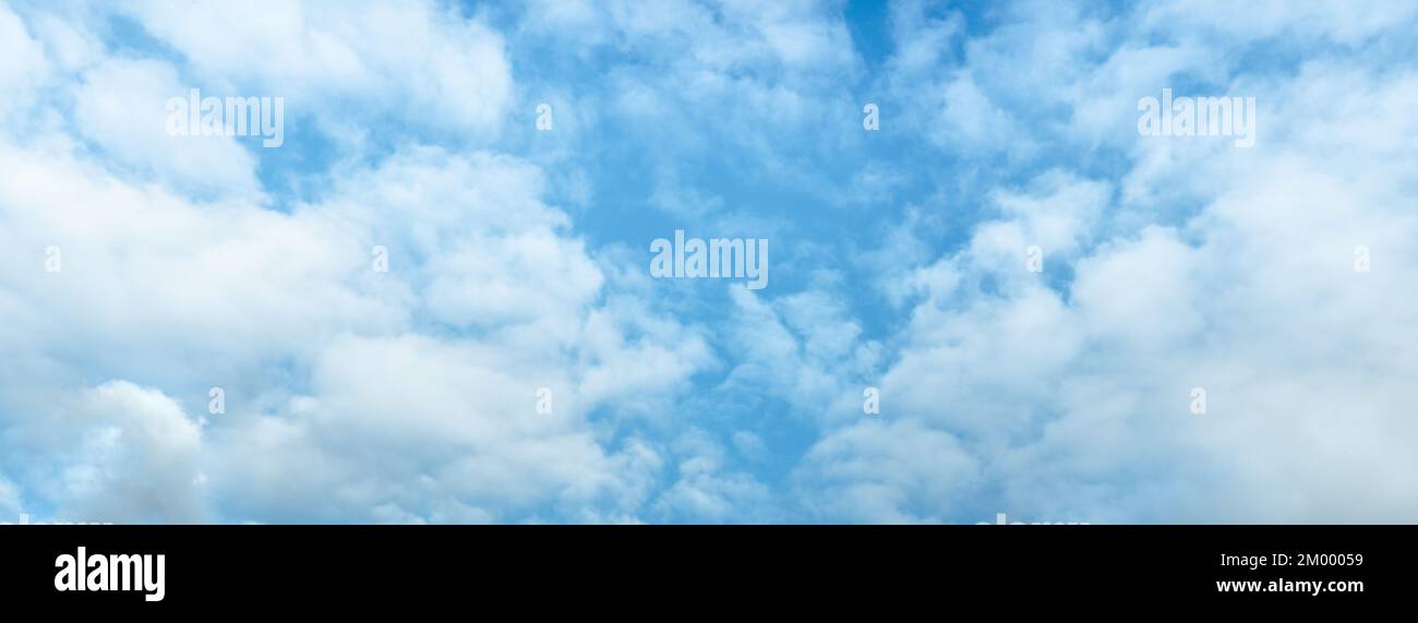 Blue sky and white clouds floated in sky on clear day with sunshine combined with cool breeze. Beautiful cloudy sky background. Panoramic composition Stock Photo